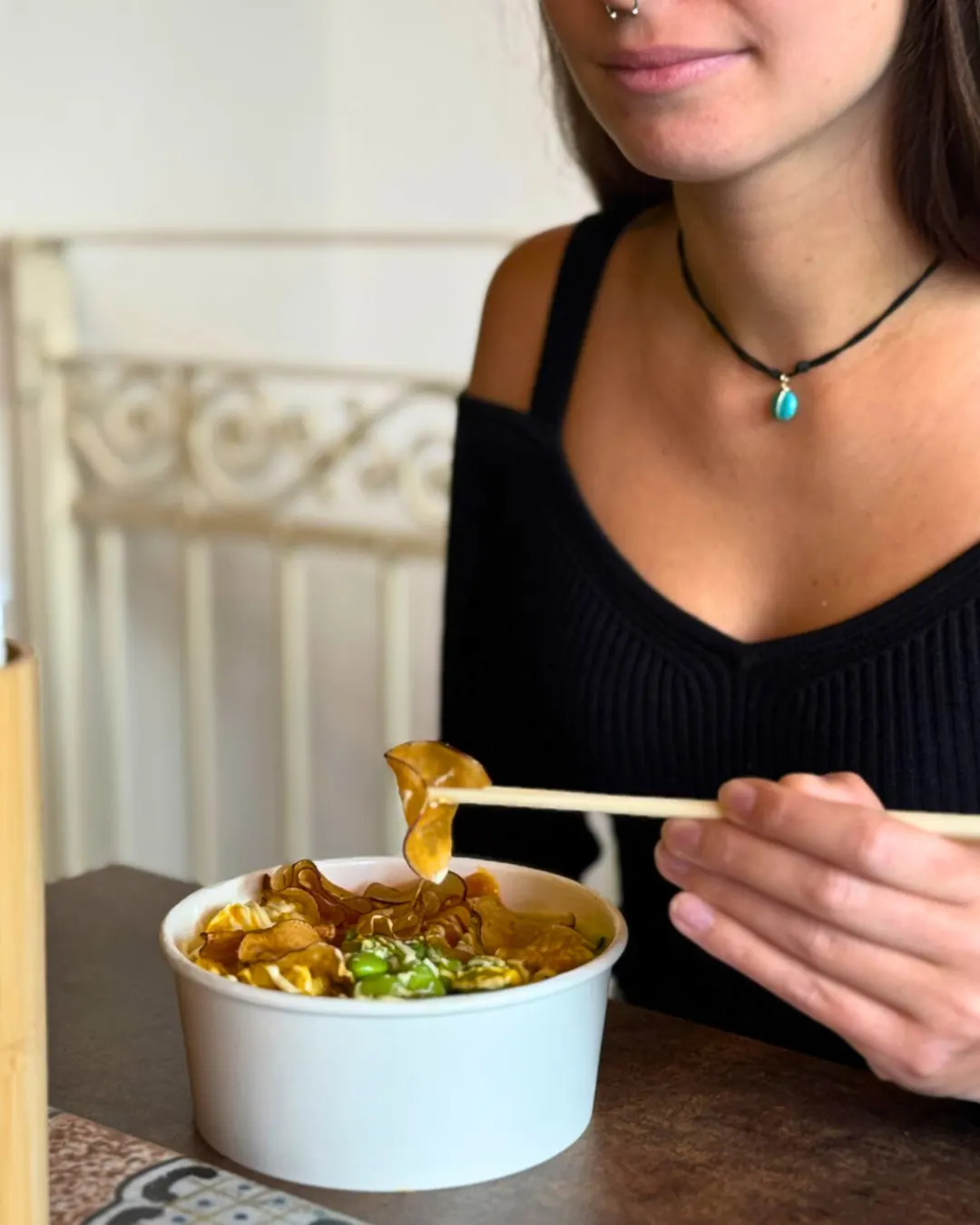 A customer eating a Maw Poké bowl
